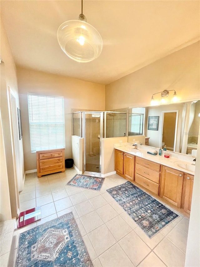 2244 NW 101st St, Gainesville, FL 32606 - full bathroom with a stall shower, tile patterned flooring, double vanity, and baseboards