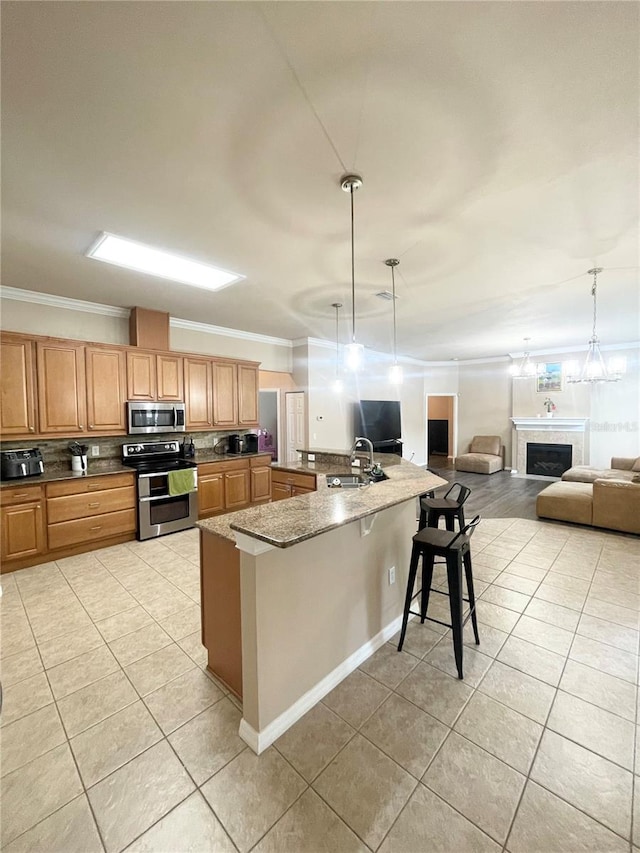 2244 NW 101st St, Gainesville, FL 32606 - kitchen with stainless steel appliances, light tile patterned floors, crown molding, a sink, and decorative backsplash