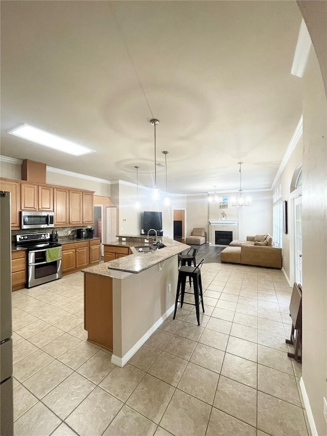 2244 NW 101st St, Gainesville, FL 32606 - kitchen with stainless steel appliances, ornamental molding, light tile patterned floors, open floor plan, and a fireplace
