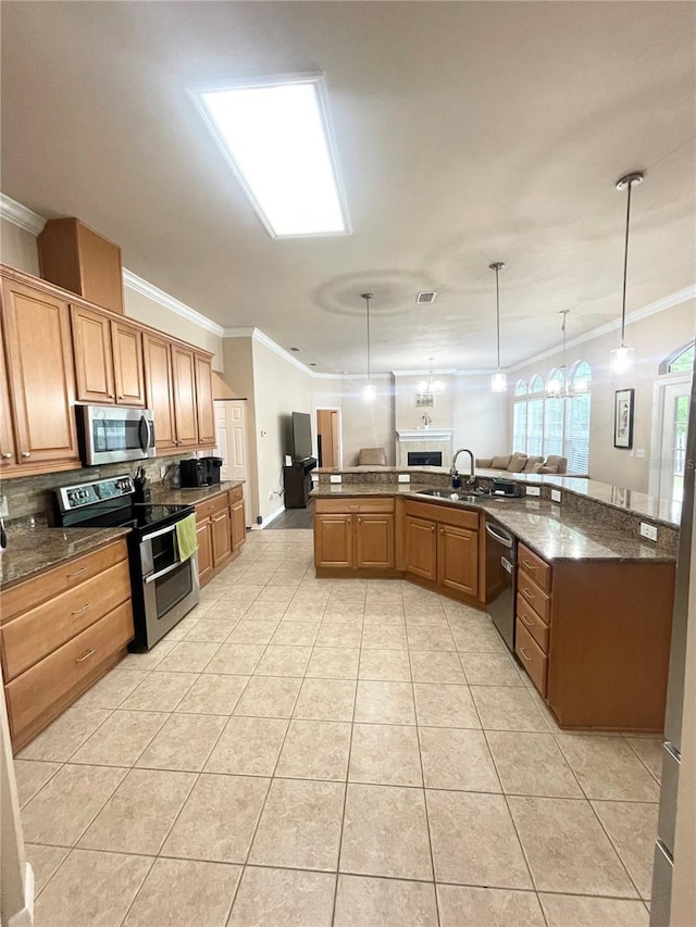 2244 NW 101st St, Gainesville, FL 32606 - kitchen featuring appliances with stainless steel finishes, ornamental molding, a sink, light tile patterned floors, and decorative light fixtures