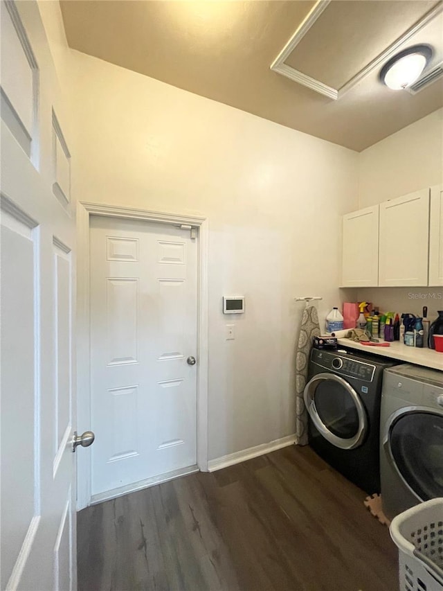 2244 NW 101st St, Gainesville, FL 32606 - washroom with cabinet space, washer and dryer, dark wood-style flooring, and baseboards