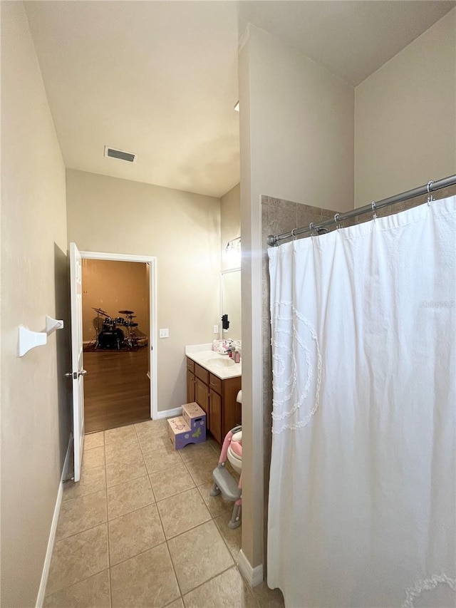 2244 NW 101st St, Gainesville, FL 32606 - bathroom with baseboards, tile patterned flooring, vanity, and curtained shower