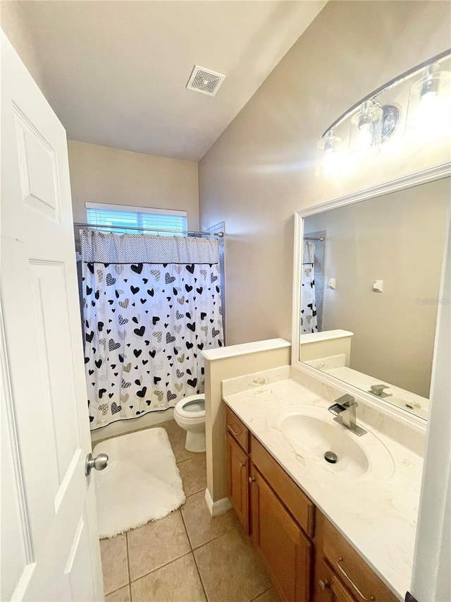 2244 NW 101st St, Gainesville, FL 32606 - bathroom featuring toilet, tile patterned flooring, vanity, and curtained shower