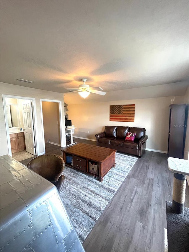 2244 NW 101st St, Gainesville, FL 32606 - living room with baseboards, wood finished floors, and ceiling fan