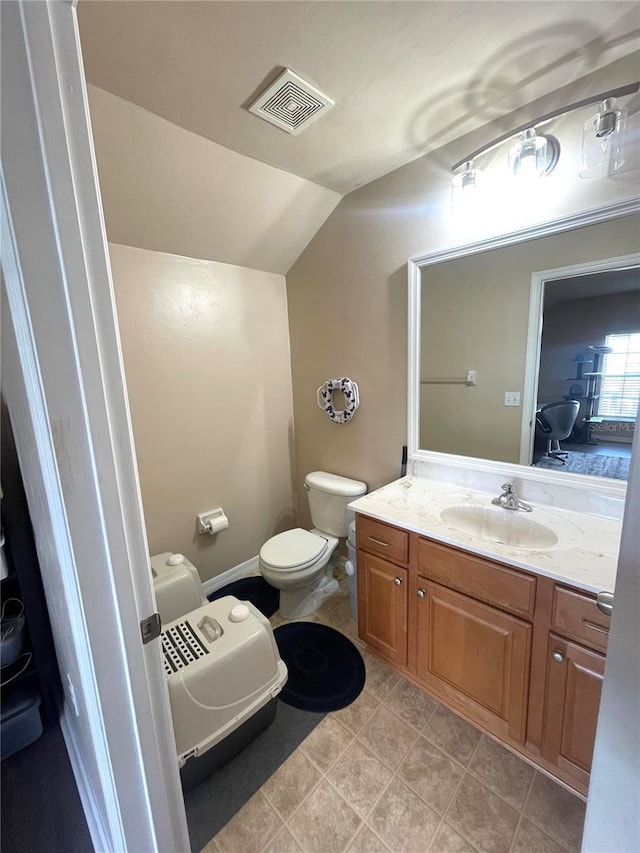 2244 NW 101st St, Gainesville, FL 32606 - bathroom with lofted ceiling, toilet, and vanity