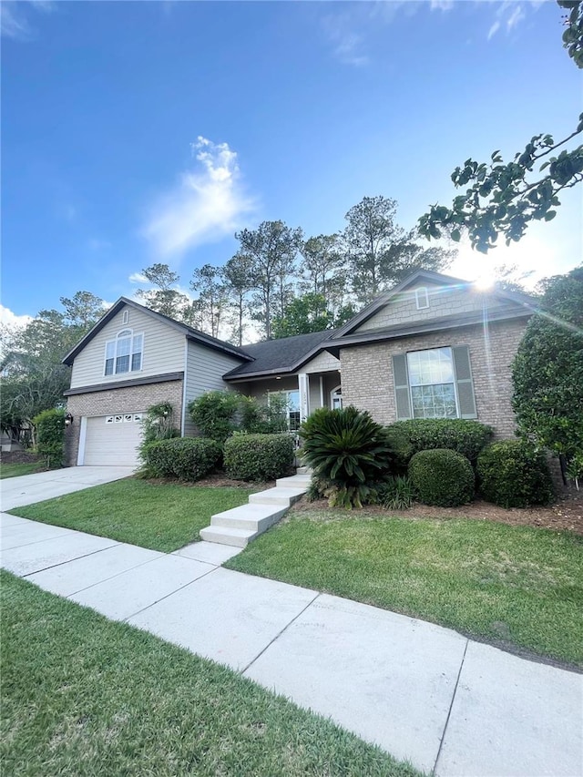 2244 NW 101st St, Gainesville, FL 32606 - view of front of home featuring brick siding, an attached garage, and a front yard