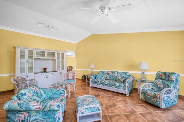 3224 Hilary Cir, Palm Harbor, FL 34684 - tiled living area featuring a ceiling fan, crown molding, vaulted ceiling, a textured ceiling, and track lighting
