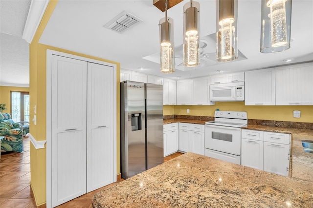 3224 Hilary Cir, Palm Harbor, FL 34684 - kitchen featuring white appliances, light tile patterned floors, light stone countertops, and white cabinetry