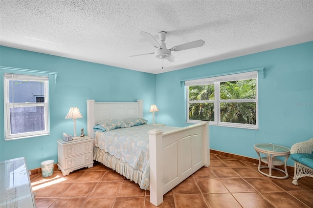3224 Hilary Cir, Palm Harbor, FL 34684 - tiled bedroom featuring a textured ceiling, baseboards, and a ceiling fan