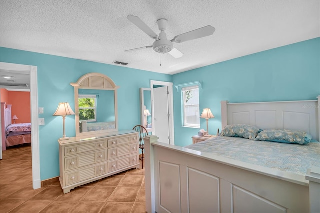 3224 Hilary Cir, Palm Harbor, FL 34684 - bedroom with multiple windows, a textured ceiling, light tile patterned flooring, and ceiling fan