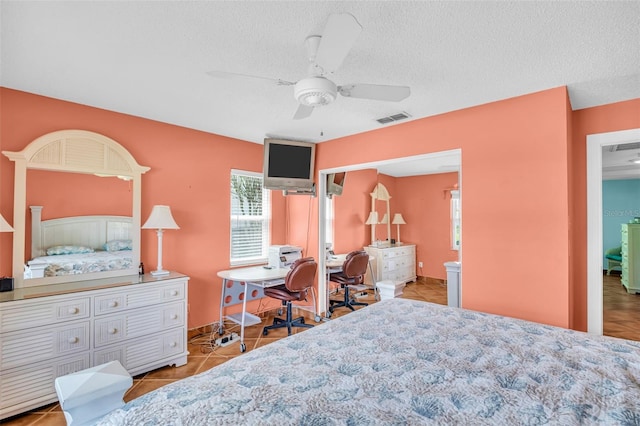 3224 Hilary Cir, Palm Harbor, FL 34684 - bedroom featuring a textured ceiling, a desk, tile patterned floors, and ceiling fan