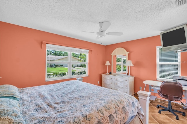 3224 Hilary Cir, Palm Harbor, FL 34684 - bedroom featuring a textured ceiling, an office area, ceiling fan, and tile patterned floors