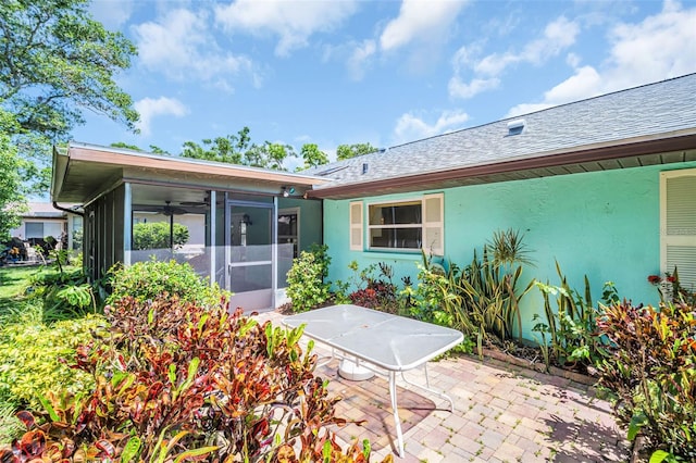 3224 Hilary Cir, Palm Harbor, FL 34684 - rear view of house with a sunroom, a patio, stucco siding, and roof with shingles