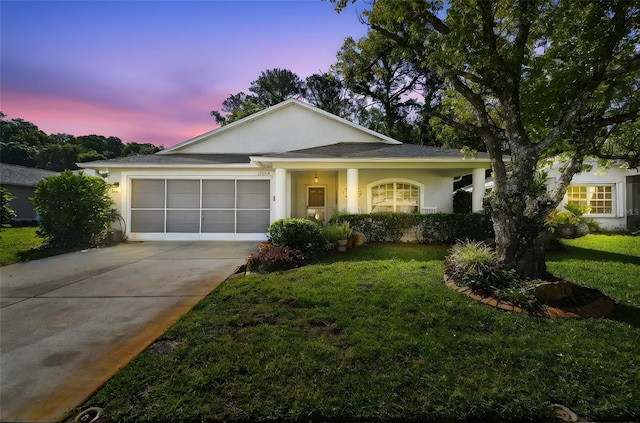 11446 Sinatra Ct, New Port Richey, FL 34654 - view of front of property with driveway, an attached garage, a lawn, and stucco siding