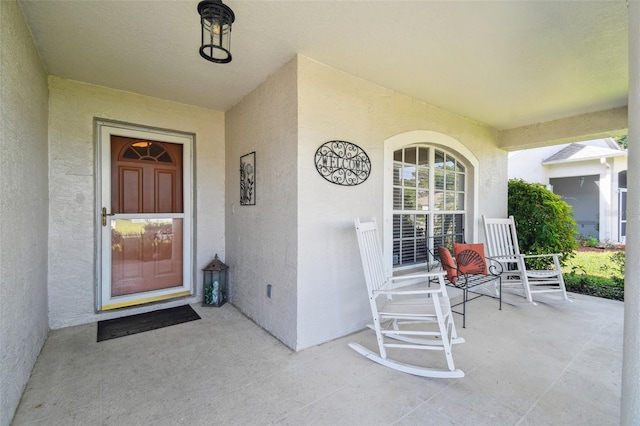 11446 Sinatra Ct, New Port Richey, FL 34654 - entrance to property with a porch and stucco siding