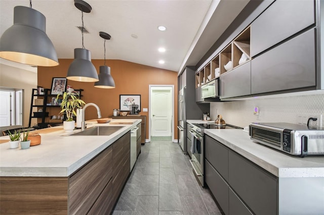 11446 Sinatra Ct, New Port Richey, FL 34654 - kitchen with stainless steel appliances, a sink, vaulted ceiling, a center island with sink, and light countertops