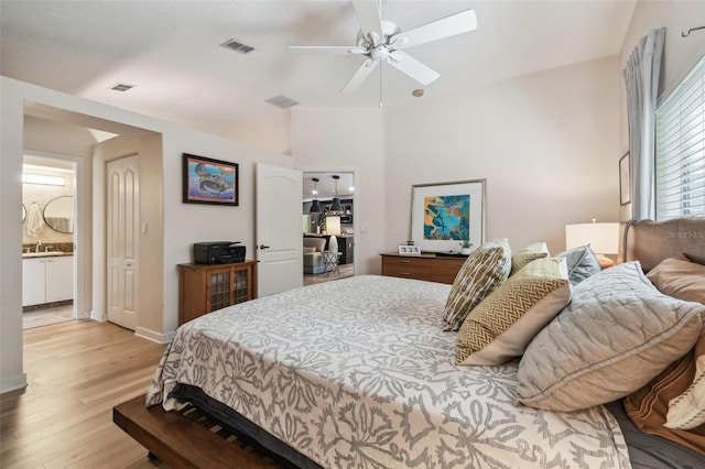 11446 Sinatra Ct, New Port Richey, FL 34654 - bedroom with light wood-style flooring, ensuite bath, ceiling fan, and a skylight