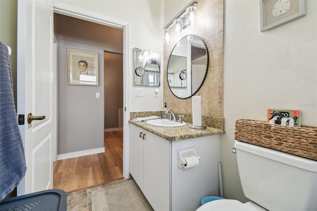 11446 Sinatra Ct, New Port Richey, FL 34654 - bathroom with vanity, toilet, and baseboards
