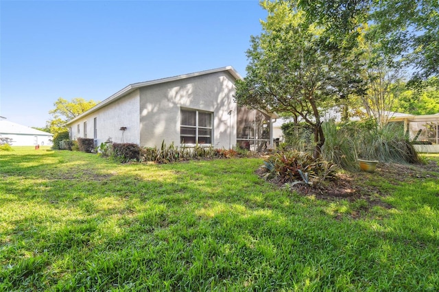 11446 Sinatra Ct, New Port Richey, FL 34654 - back of house with stucco siding and a lawn