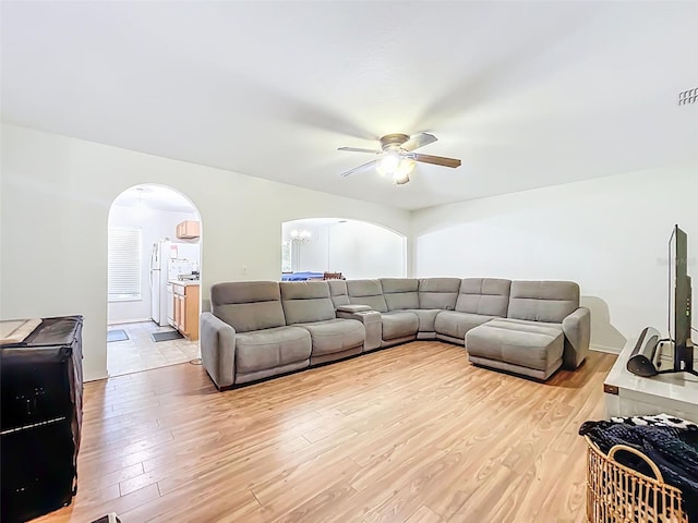 4732 Ashburn Pond Way, Tampa, FL 33610 - living room featuring arched walkways, ceiling fan, and light wood-style flooring