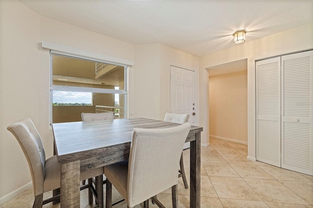 6105 Bahia Del Mar Cir Unit 683, Saint Petersburg, FL 33715 - dining space featuring baseboards and light tile patterned floors