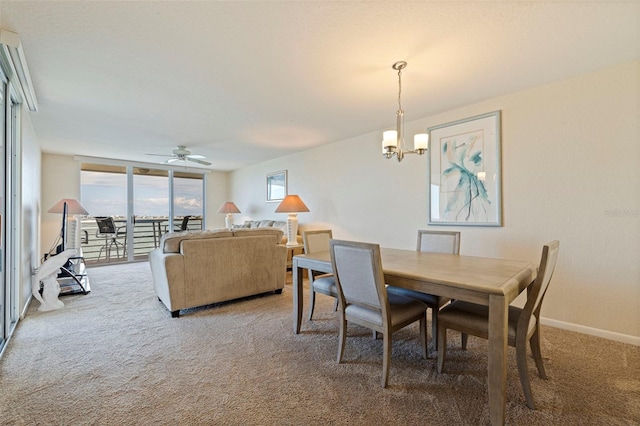 6105 Bahia Del Mar Cir Unit 683, Saint Petersburg, FL 33715 - dining room featuring carpet floors, a chandelier, a ceiling fan, and baseboards