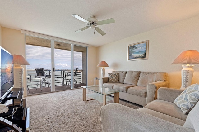 6105 Bahia Del Mar Cir Unit 683, Saint Petersburg, FL 33715 - living room with a ceiling fan, carpet flooring, floor to ceiling windows, and a textured ceiling