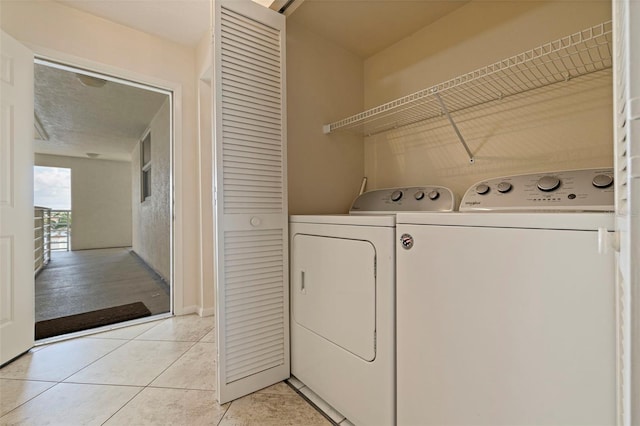 6105 Bahia Del Mar Cir Unit 683, Saint Petersburg, FL 33715 - laundry room featuring washing machine and clothes dryer and light tile patterned flooring