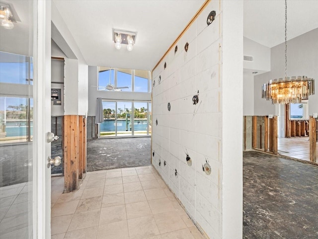 hallway featuring a chandelier and a water view