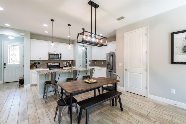 17847 Althea Blue Pl, Lutz, FL 33558 - dining area with light wood-style floors, recessed lighting, and baseboards