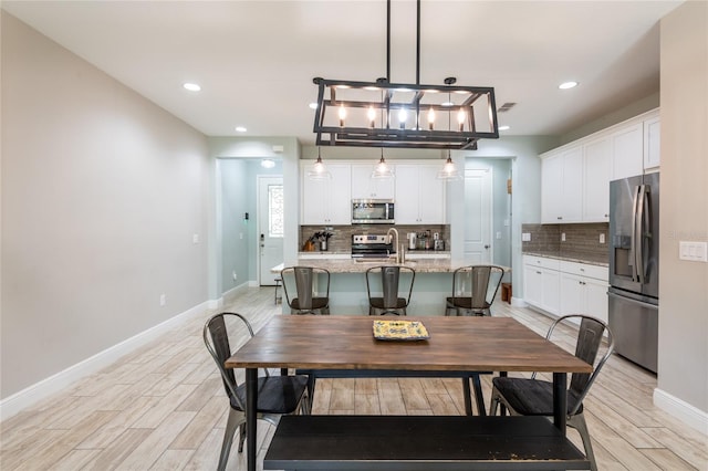 17847 Althea Blue Pl, Lutz, FL 33558 - dining area with baseboards, light wood-type flooring, and recessed lighting