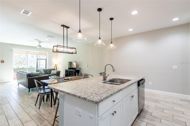17847 Althea Blue Pl, Lutz, FL 33558 - kitchen with a sink, dishwasher, ceiling fan, open floor plan, and wood finish floors