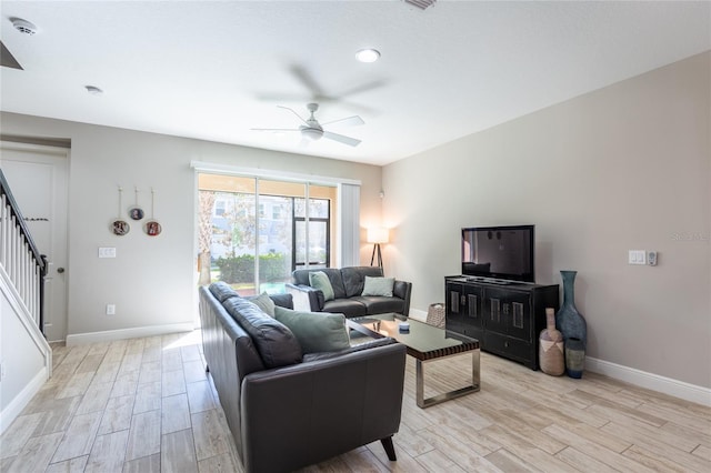 17847 Althea Blue Pl, Lutz, FL 33558 - living area with ceiling fan, light wood finished floors, baseboards, and stairway