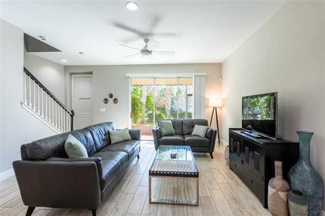17847 Althea Blue Pl, Lutz, FL 33558 - living room with ceiling fan, stairs, light wood-style flooring, baseboards, and recessed lighting