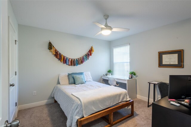 17847 Althea Blue Pl, Lutz, FL 33558 - bedroom featuring light colored carpet, a desk, baseboards, and a ceiling fan