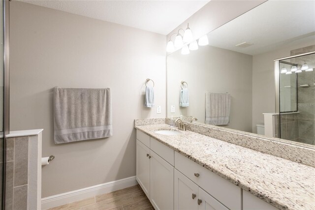 17847 Althea Blue Pl, Lutz, FL 33558 - full bathroom with toilet, a stall shower, baseboards, and vanity