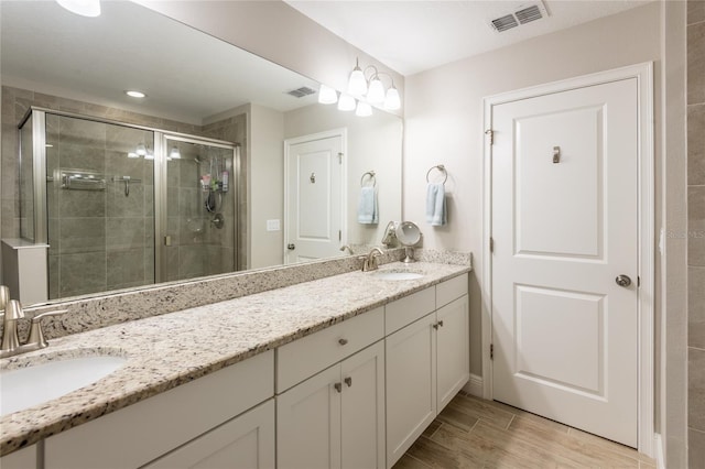 17847 Althea Blue Pl, Lutz, FL 33558 - full bath with a stall shower, double vanity, and wood finished floors