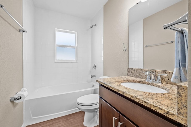 6937 Gideon Cir, Zephyrhills, FL 33541 - bathroom with vanity, wood finished floors, toilet, shower / tub combination, and a textured wall