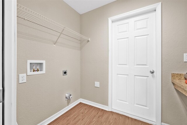 6937 Gideon Cir, Zephyrhills, FL 33541 - washroom with hookup for an electric dryer, light wood-style floors, washer hookup, and baseboards