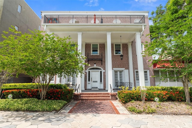 219 4th Ave N Unit 201, Saint Petersburg, FL 33701 - greek revival house featuring a porch, brick siding, and a balcony