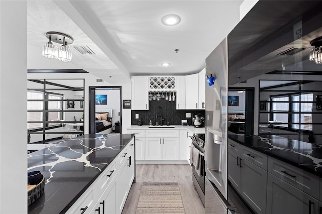 219 4th Ave N Unit 201, Saint Petersburg, FL 33701 - kitchen featuring a sink, light wood finished floors, stainless steel range oven, a chandelier, and recessed lighting