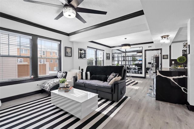 219 4th Ave N Unit 201, Saint Petersburg, FL 33701 - living area featuring light wood-type flooring, ornamental molding, ceiling fan, and baseboards