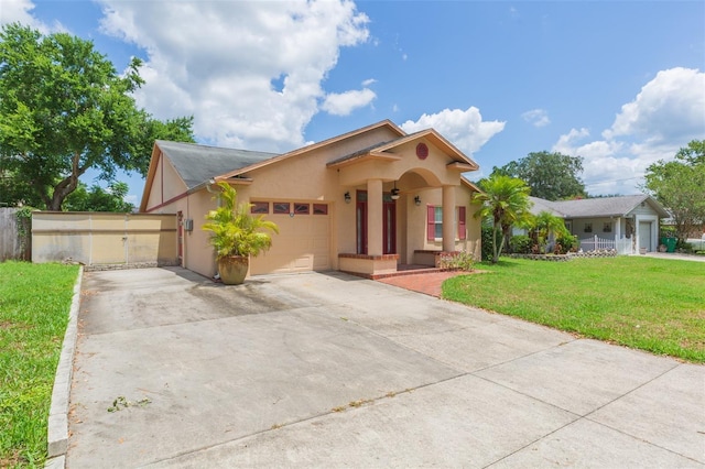 view of front of home featuring stucco siding, an attached garage, and driveway