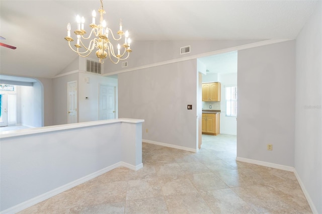 empty room with lofted ceiling, a chandelier, baseboards, and a ceiling fan