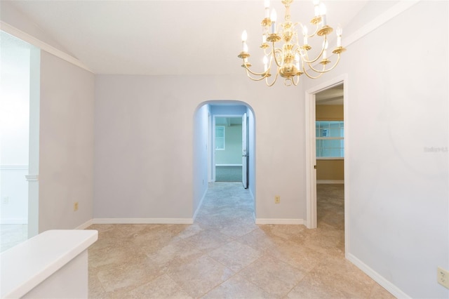 unfurnished room with arched walkways, a chandelier, and baseboards