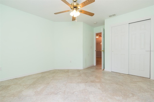 unfurnished bedroom with a closet, baseboards, and ceiling fan