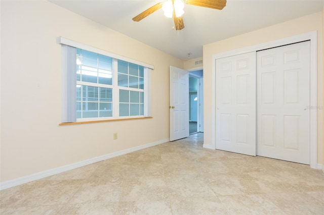 unfurnished bedroom featuring a closet, baseboards, and a ceiling fan