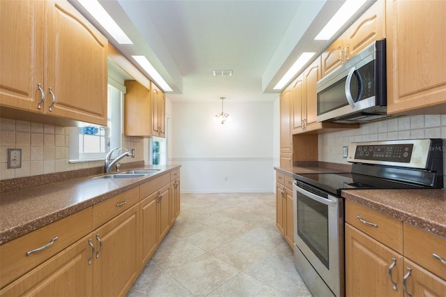 kitchen featuring stainless steel appliances, a sink, dark countertops, and backsplash