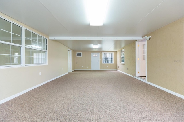 carpeted empty room with baseboards