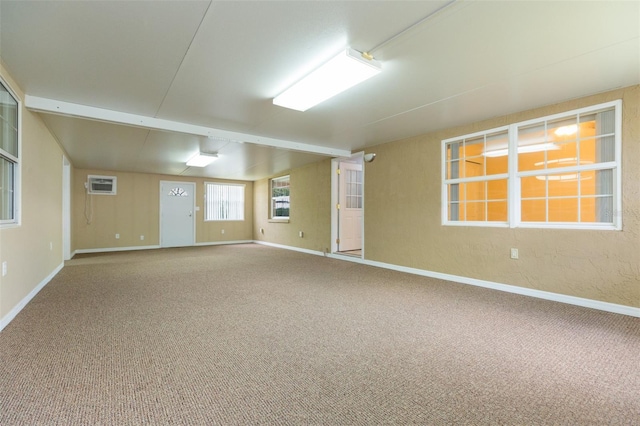 carpeted spare room featuring baseboards